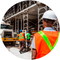 Construction workers inspecting site with safety gear
