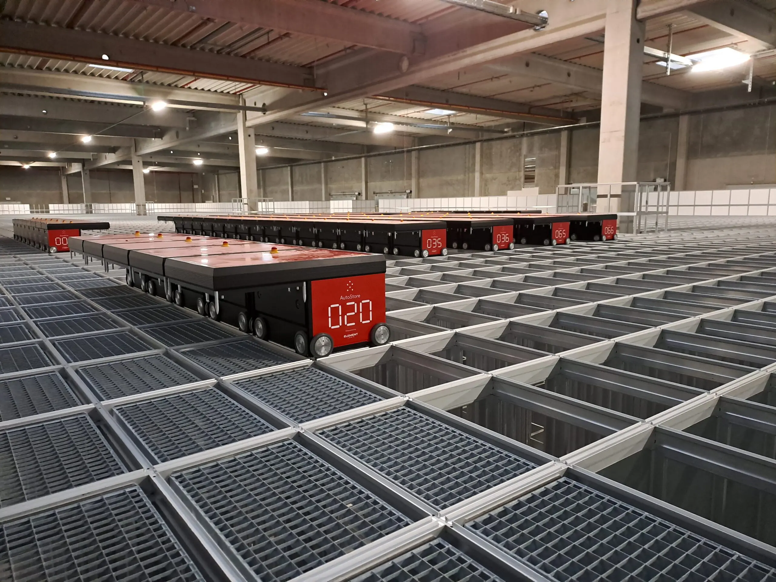 Warehouse with automated storage robots on grid system.