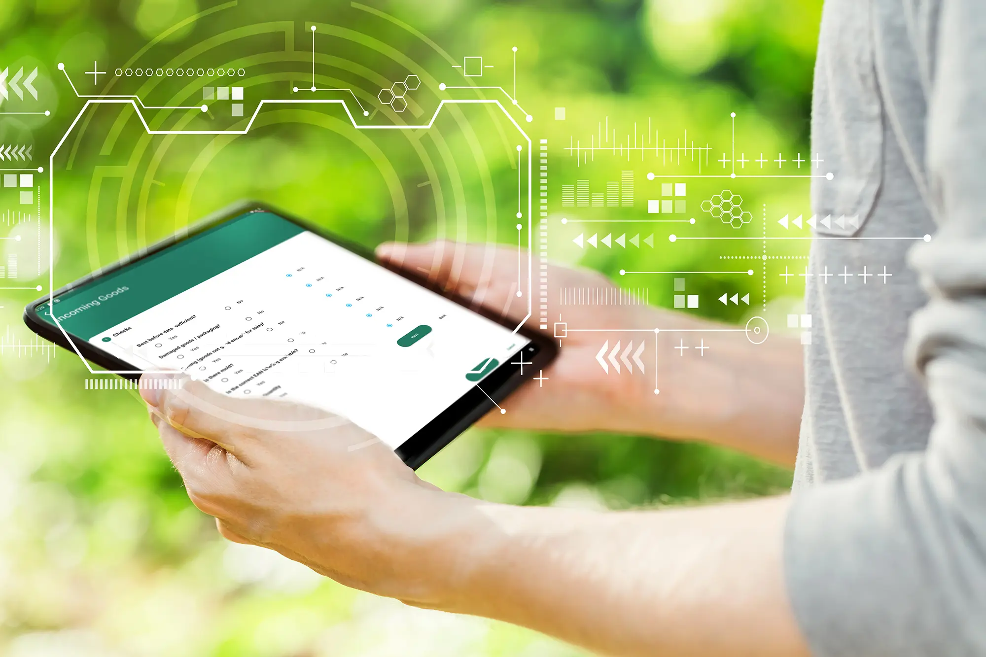 Person using tablet with digital interface overlay