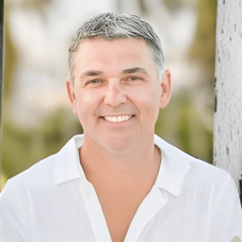 Smiling person in white shirt outdoors