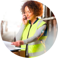 Warehouse worker discussing logistics on the phone.