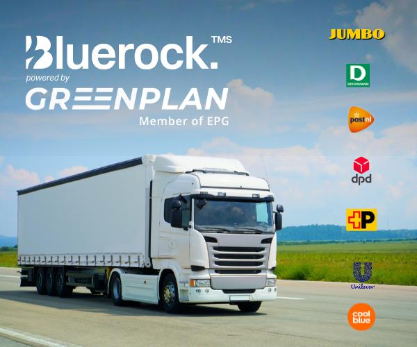 Truck on road with company logos in background.