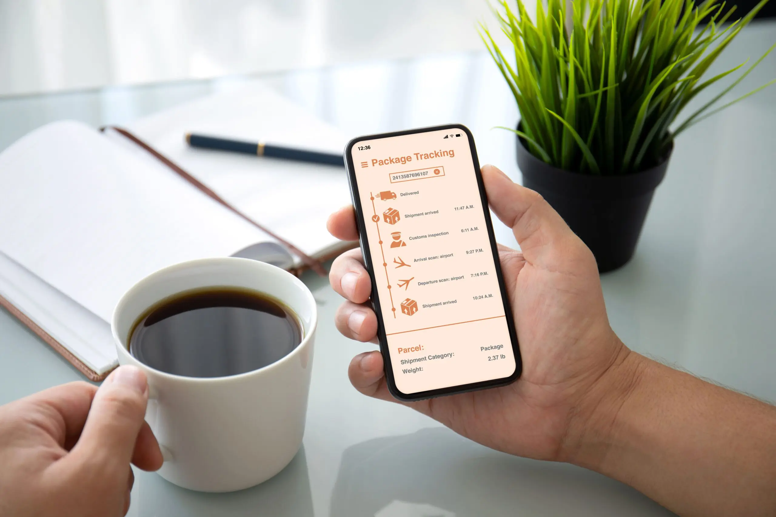Person checking package tracking app on phone.