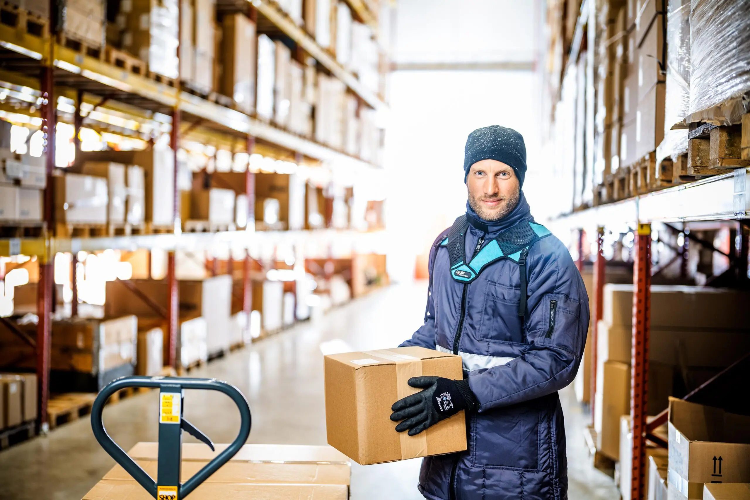 Warehouse worker holding a cardboard box.