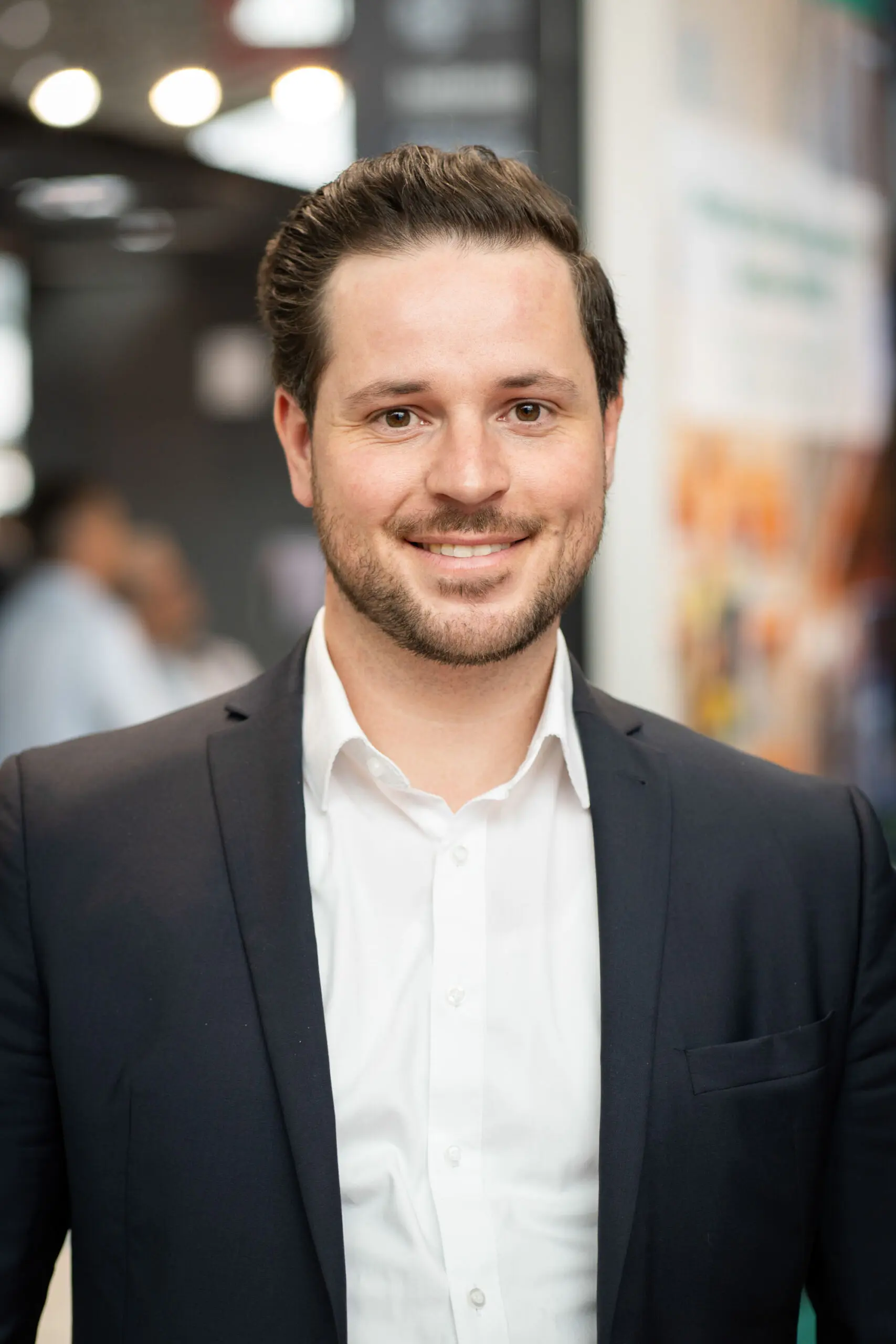 Smiling person in professional attire indoors