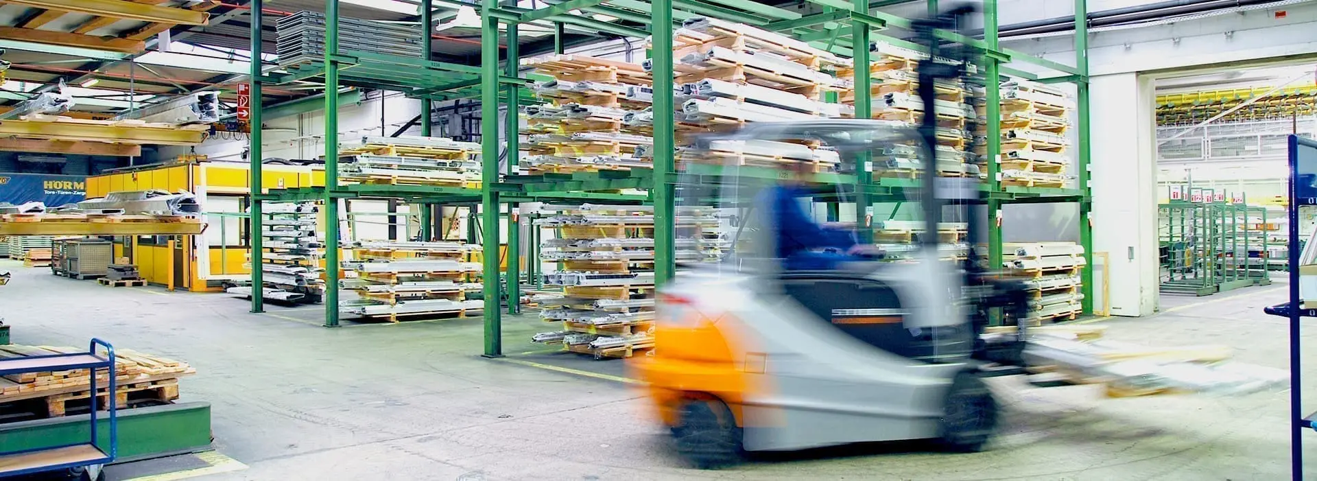 Forklift moving pallets in a warehouse.