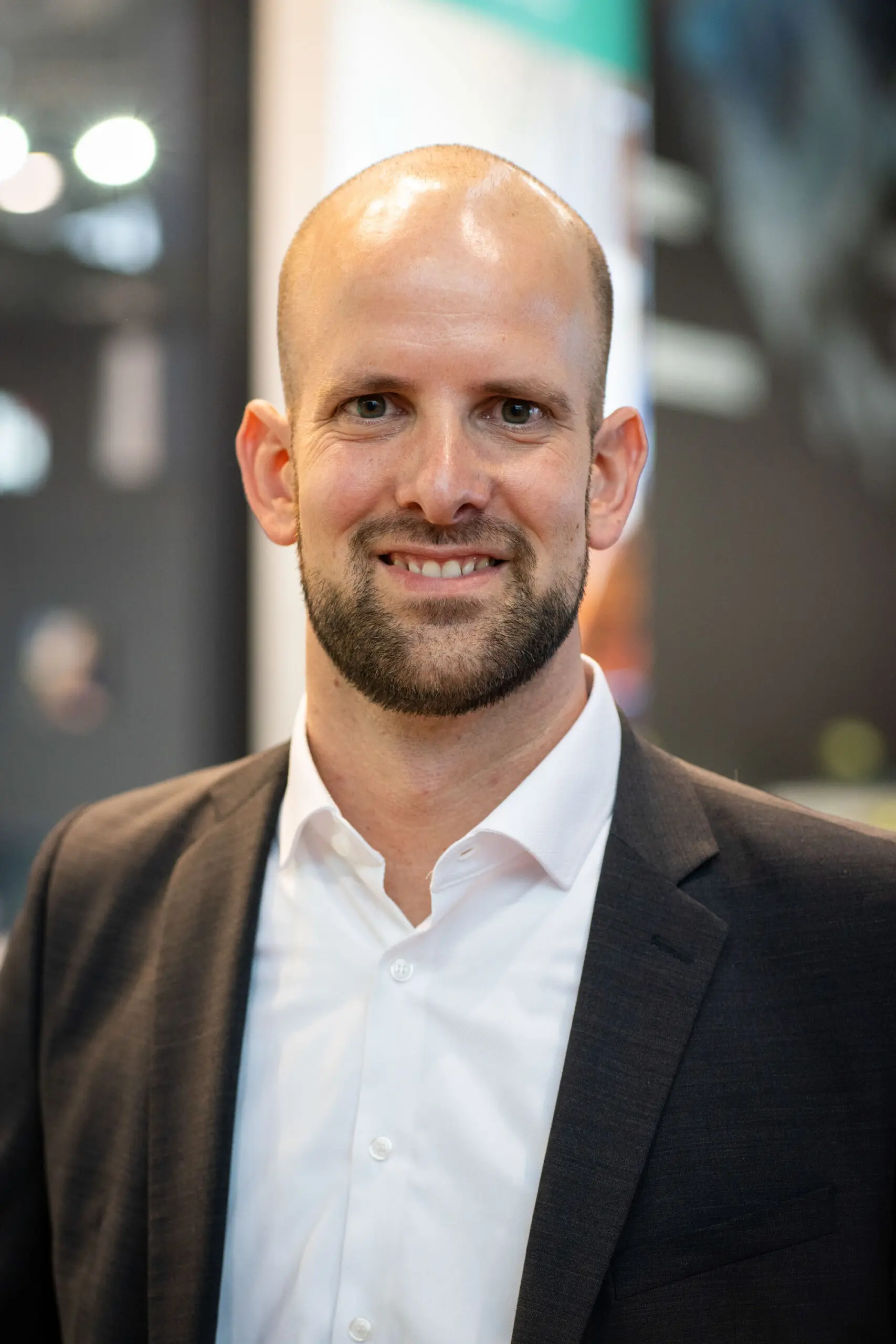 Smiling man in suit and white shirt