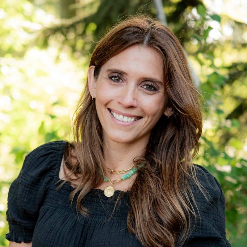 Smiling woman outdoors with green background