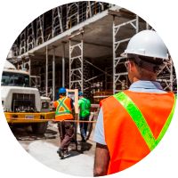 Construction workers inspecting site with safety gear