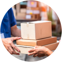 Two people exchanging delivery boxes outdoors