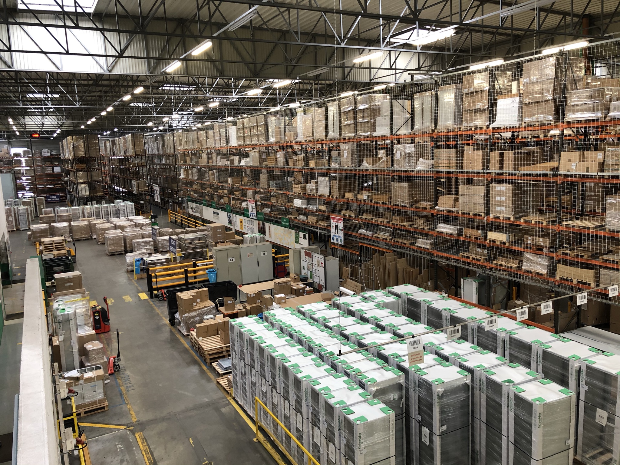 Large warehouse with stacked boxes and pallets.