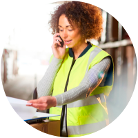 Warehouse worker discussing logistics on the phone.