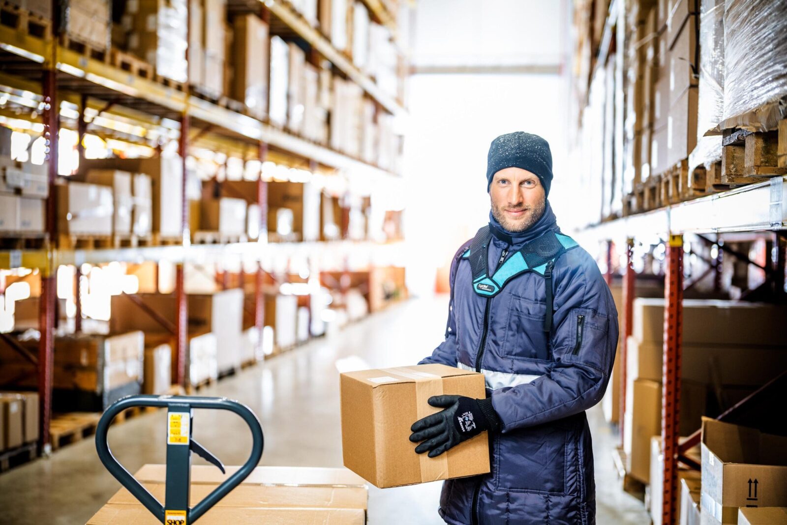 Warehouse worker holding a cardboard box.