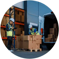 Workers loading boxes into delivery van.