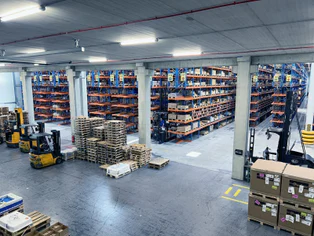 Warehouse with shelves and forklifts