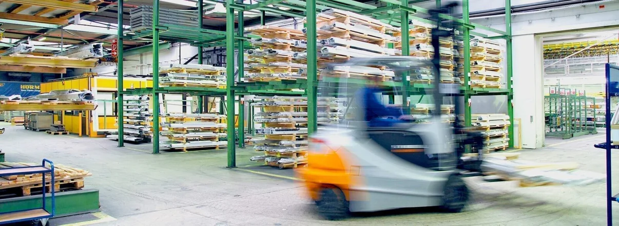 Forklift moving pallets in a warehouse.