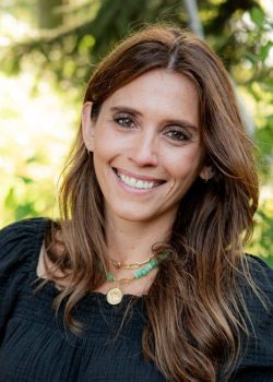 Smiling woman outdoors with green background
