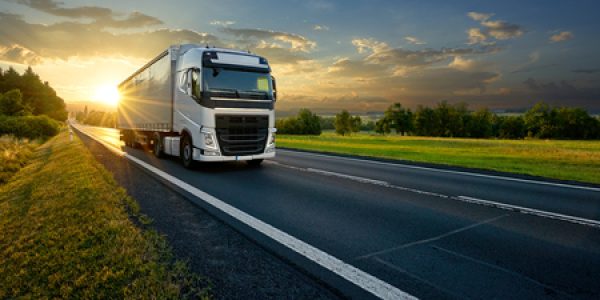 White truck driving on highway during sunset