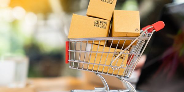 Shopping cart with boxes on laptop