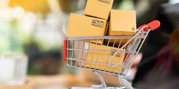 Shopping cart with boxes on laptop