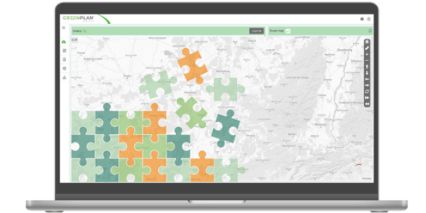 Laptop displaying map with colorful puzzle overlay.