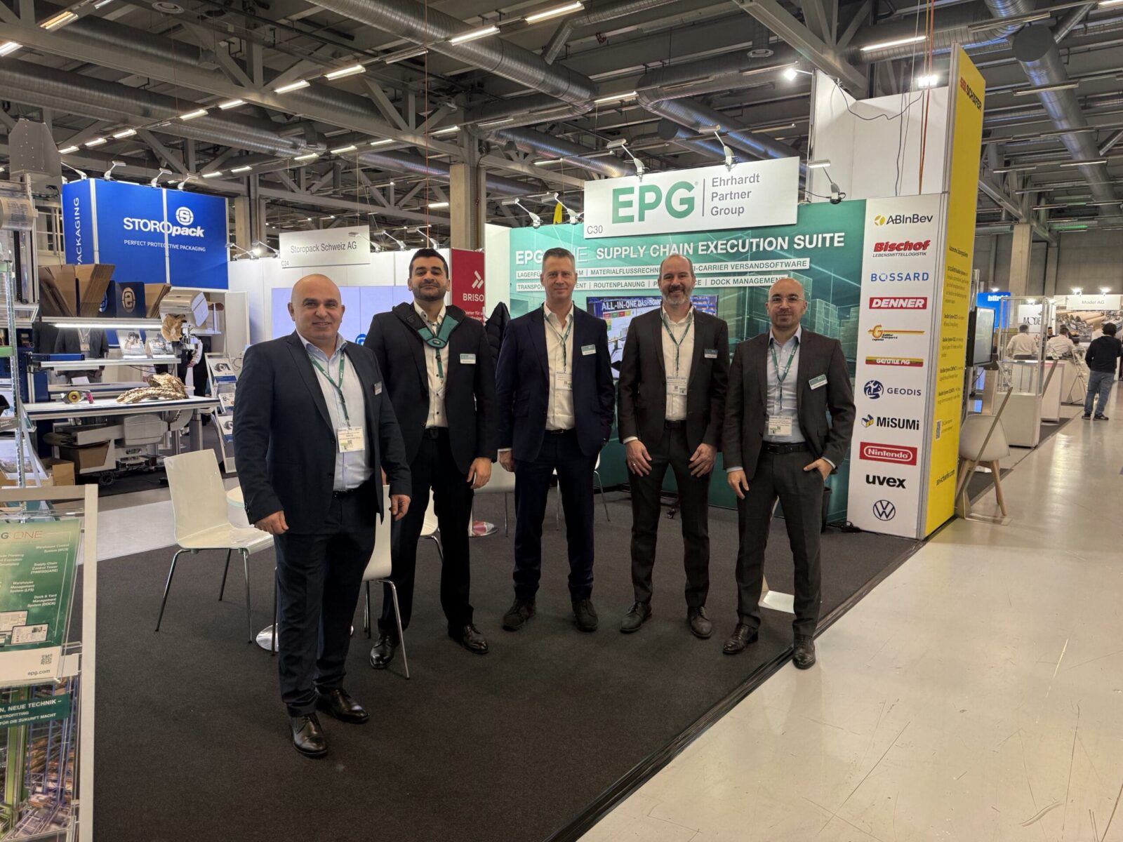 Trade show booth with five business professionals.